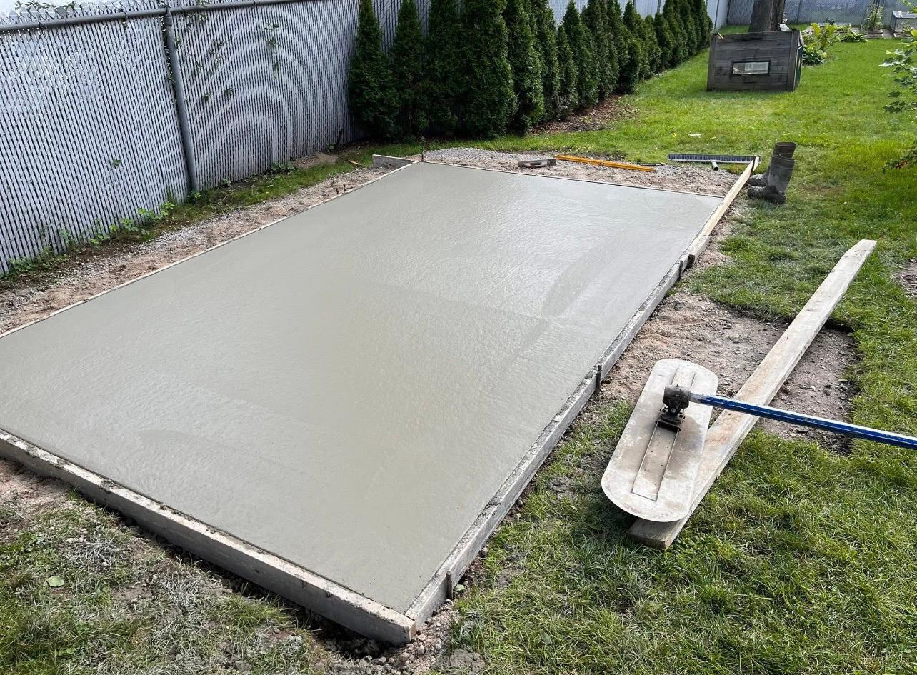 Fresh concrete pad being finished with bull float by Leeonitis Contracting London Ontario